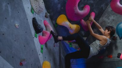 Strong woman in climbing gym